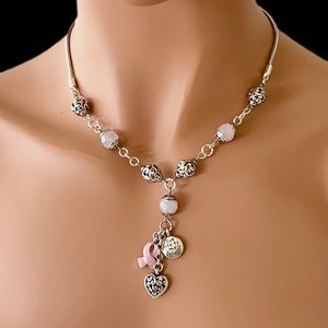 Brighton Power of Pink Necklace. Has charms at the bottom.  Silver plated.